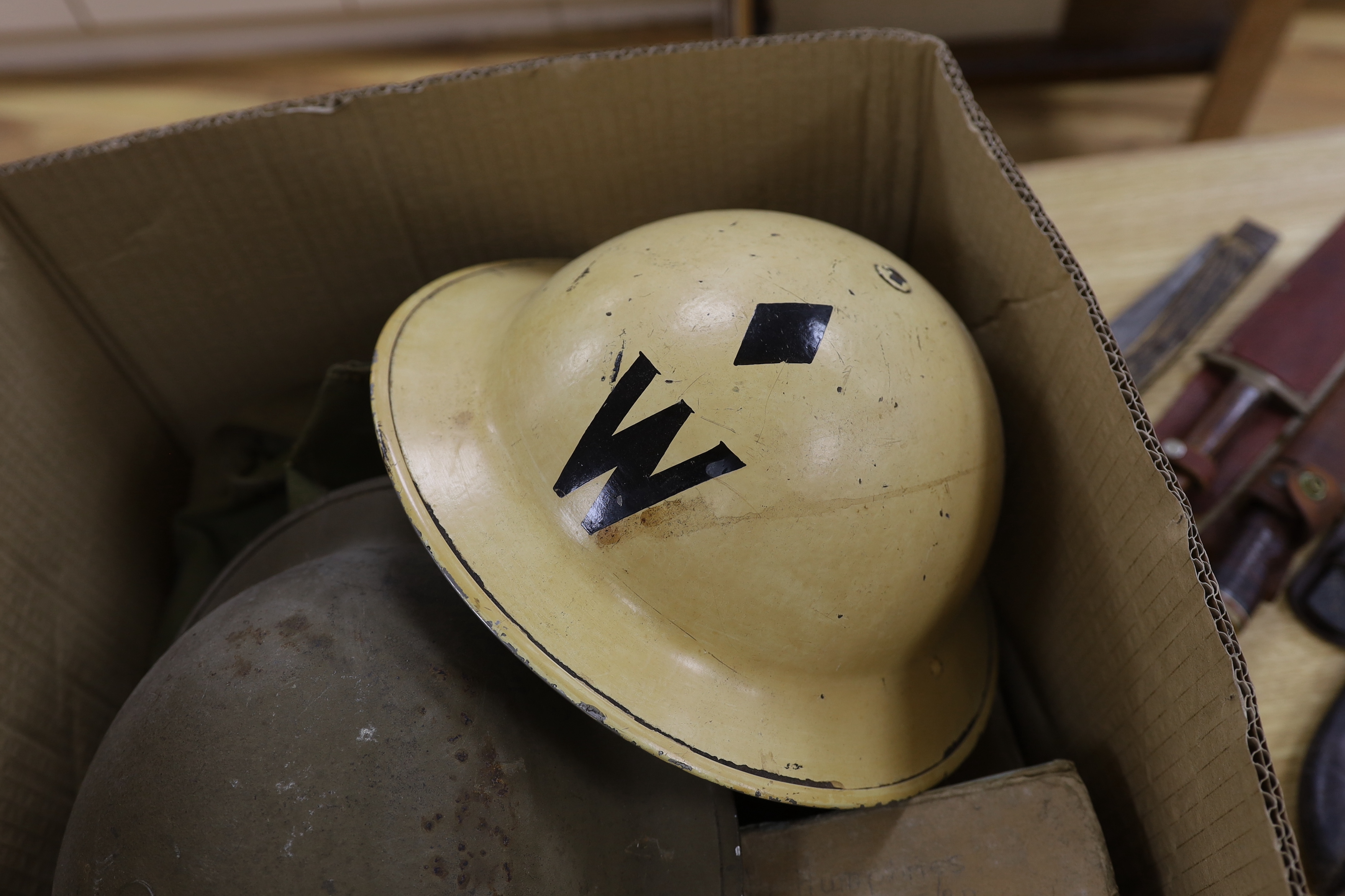 Six military etc. tin helmets. Including an example, painted as an Air Raid Warden’s helmet, with other items, including a military shoulder bag etc.